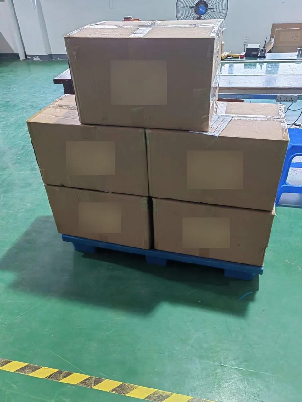 Cartons of scales stacked on a pallet at the factory warehouse
